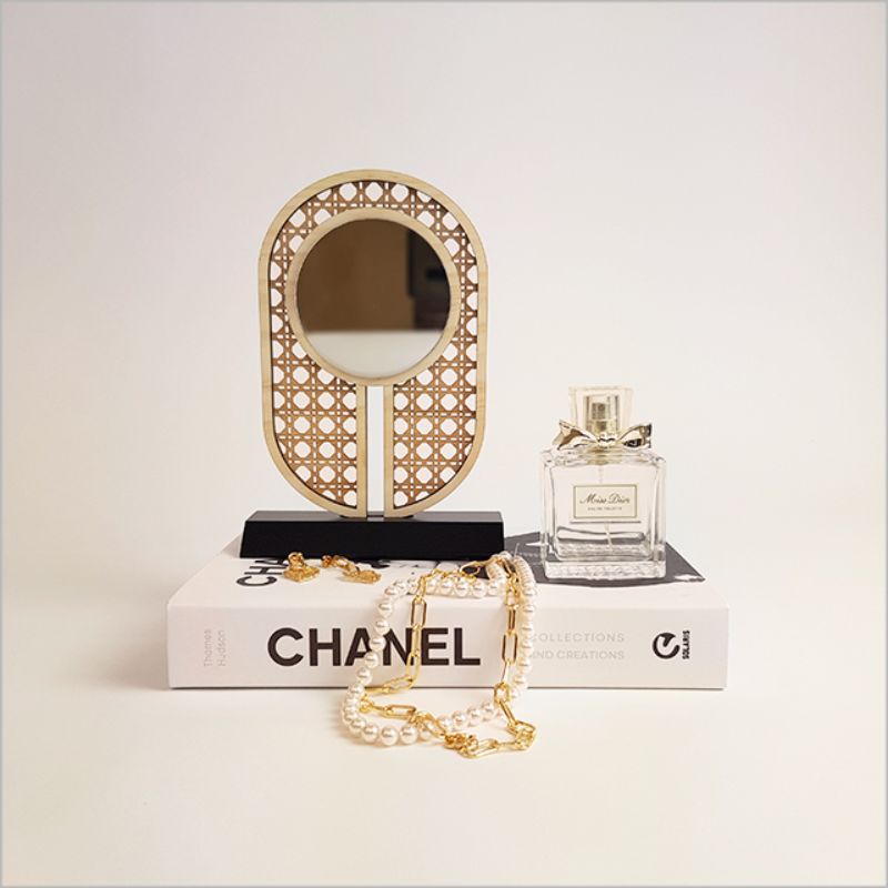 Elegant rattan-inspired earring stand with integrated mirror, perfect for organizing and showcasing jewelry.