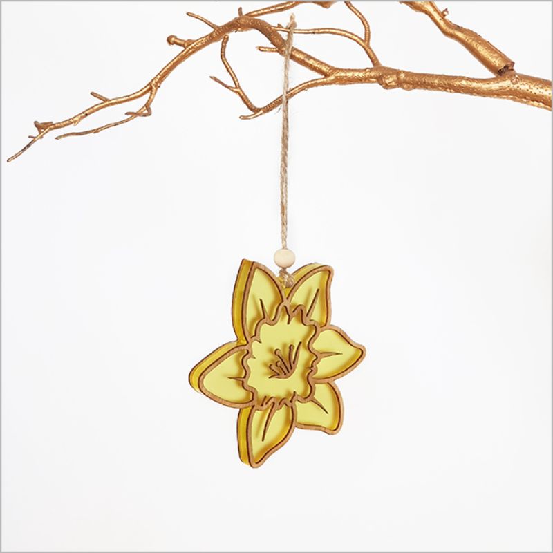 Hanging daffodil ornament made from bamboo and yellow satin acrylic, perfect for vibrant home decor.