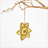 Hanging daffodil ornament made from bamboo and yellow satin acrylic, perfect for vibrant home decor.