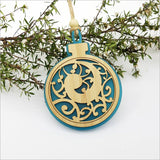 Teal satin acrylic bauble ornament featuring a Koru design, perfect for holiday decor or year-round hanging.