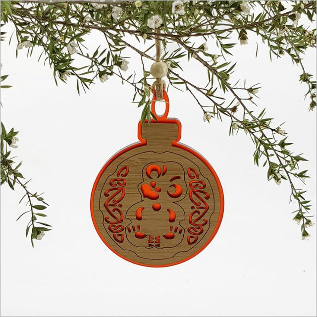 Red satin acrylic hanging ornament featuring a tiki design with laser-cut bamboo, perfect for festive decor and gifting.