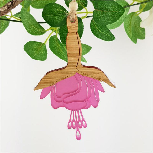 Fuchsia Flower Hanging Ornament made of bamboo and pink satin acrylic, perfect for adding vibrant color to any decor.
