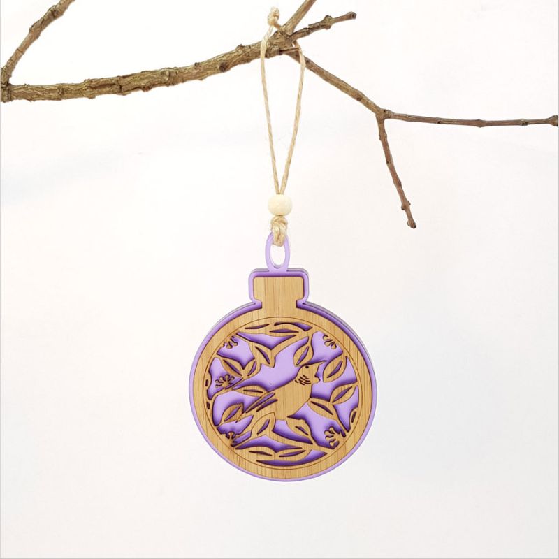 Purple satin acrylic bauble featuring a Tui bird on a Pohutukawa tree, perfect for holiday decor or as a unique Kiwi gift.