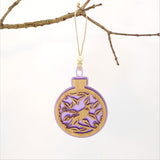 Purple satin acrylic bauble featuring a Tui bird on a Pohutukawa tree, perfect for holiday decor or as a unique Kiwi gift.
