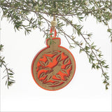 Red acrylic bauble ornament featuring a Tui on a Pohutukawa branch, perfect for festive decor or thoughtful gifts.