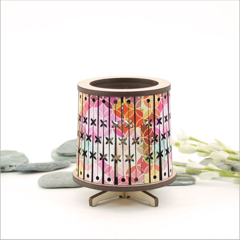 Round LED tealight holder made from laser-cut veneer, featuring a color-changing LED candle for a cozy ambiance.