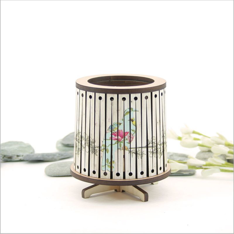 Round LED tealight holder featuring a floral Kereru design, 8.5cm diameter, with a vibrant color-changing LED candle.