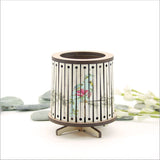 Round LED tealight holder featuring a floral Kereru design, 8.5cm diameter, with a vibrant color-changing LED candle.