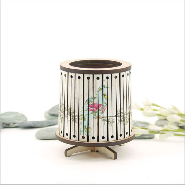 Round LED tealight holder featuring a floral Kereru design, 8.5cm diameter, with a vibrant color-changing LED candle.