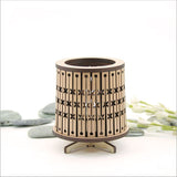 Round LED tealight holder in dark veneer, featuring a laser-cut design and color-changing LED tealight for elegant ambiance.