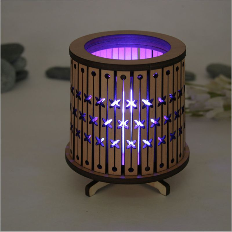 Round LED tealight holder in dark veneer with intricate laser-cut design, featuring a color-changing LED tealight.