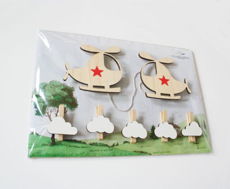 Playful helicopter-shaped pegs for displaying children's artwork, photos, and names in a creative and fun way.