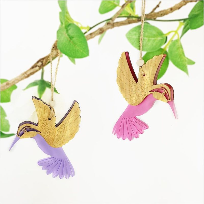 Pink satin acrylic hanging ornament shaped like a hummingbird, combining elegance with lightweight design for easy display.