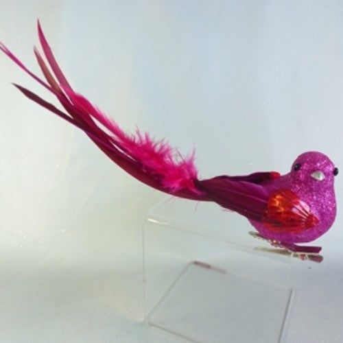 Vibrant fuschia feather bird decoration, perfect for adding elegance and color to any room or festive occasion.