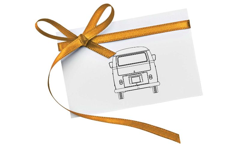 Diecast model car of a 1/43 scale VW Campervan celebrating birthdays with vibrant design and intricate details.