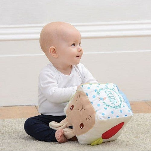 Colorful Peter Rabbit Activity Cube with interactive elements promoting sensory exploration and fine motor skills for toddlers.
