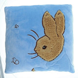 Whimsical blue Peter Rabbit cushion from Beatrix Potter, perfect for adding comfort and charm to any child's room or nursery.