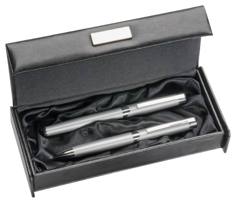 Elegant leather look pen box with magnetic closure, silver badge, and silky lining for stylish pen storage.