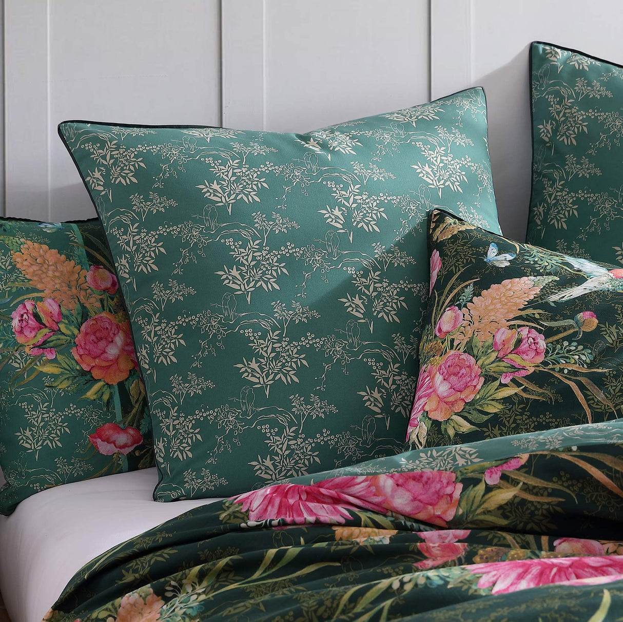 Vibrant Frolic Jade European pillowcase featuring blooms and hummingbirds, crafted from cotton and polyester with jade piping.