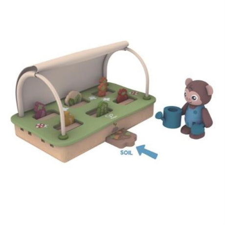 Colorful Hape Green Planet Greenhouse Set with miniature veggies, tools, and a compost bin for eco-friendly gardening play.