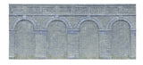 Mid level arched retaining wall set in engineers blue brick, designed for realistic model railway scenery.