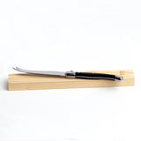 Ergonomic 23cm stainless steel cheese knife with black handle, perfect for slicing soft cheeses like feta and brie.