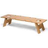 Foldable bamboo Lungo Tavolo Table with glass and bottle holders, perfect for outdoor dining and gatherings.