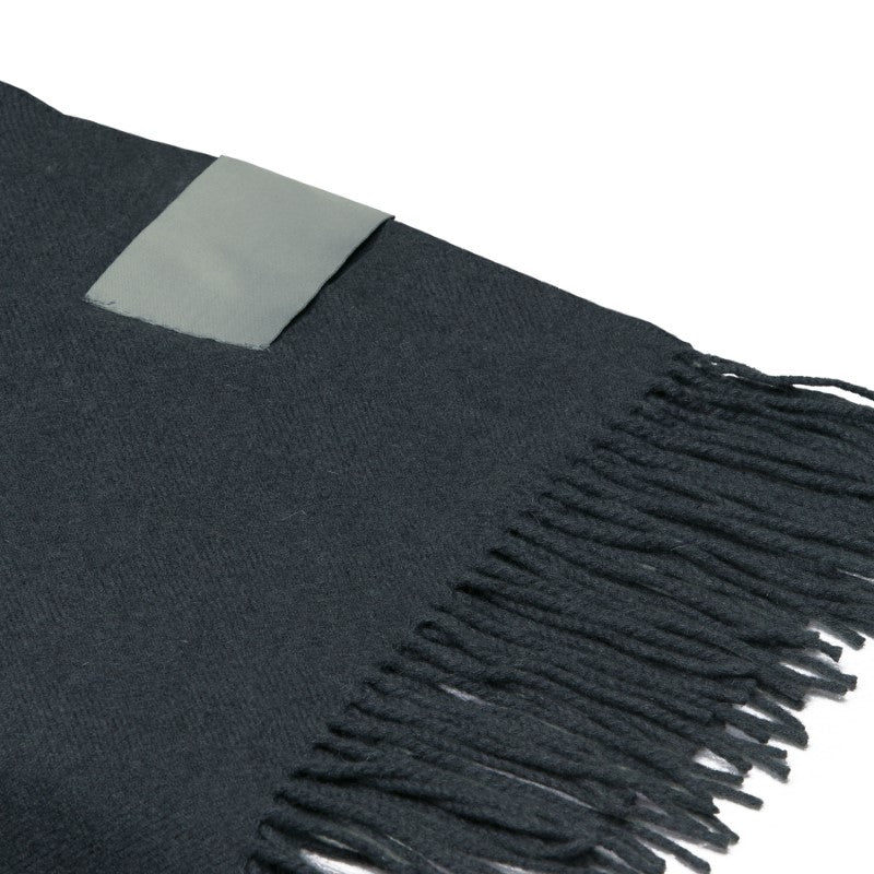 Luxury Merino wool blanket throw with herringbone weave, soft finish, and stylish fringes, perfect for cozy decor.