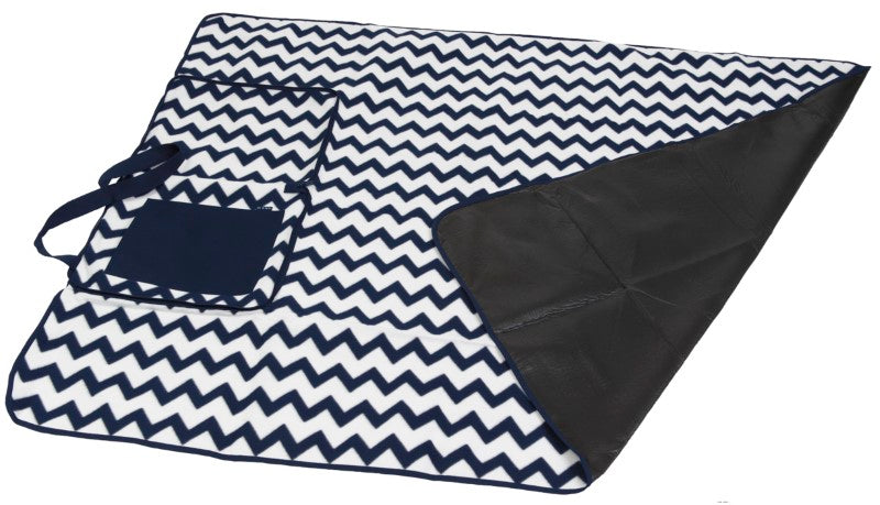 Chevron print outdoor blanket with waterproof backing, folds into a cushion for easy transport, ideal for picnics and events.