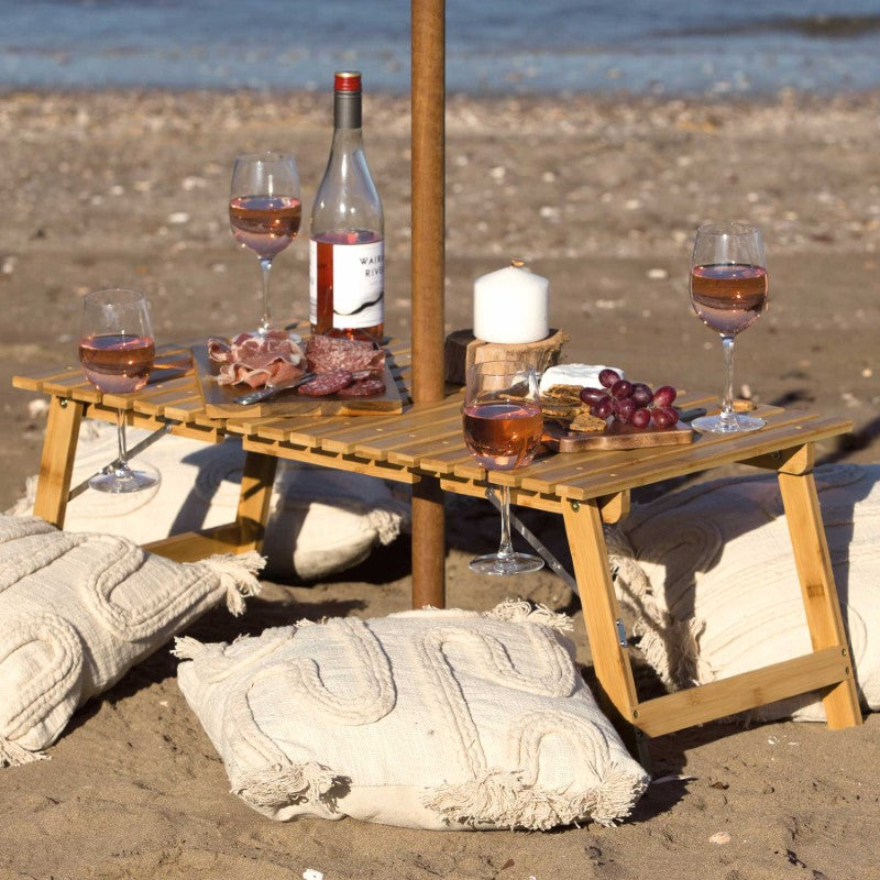 Ombrello Tavolo Table: foldable bamboo table with wine glass holders and umbrella hole, perfect for outdoor gatherings.