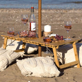 Ombrello Tavolo Table: foldable bamboo table with wine glass holders and umbrella hole, perfect for outdoor gatherings.