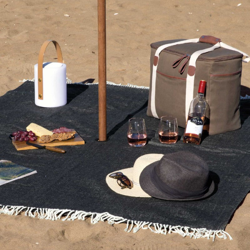 Ombrello Picnic Blanket featuring herringbone weave, waterproof backing, and integrated umbrella hole for stylish outdoor comfort.