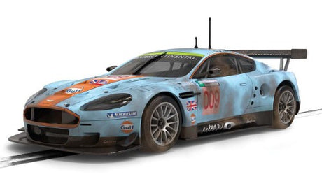 Weathered Gulf Aston Martin DBR9 slot car replica, showcasing realistic detailing and iconic livery for collectors and racers.