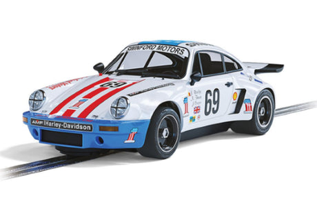 Porsche 911 Carrera RSR slot car in USA-themed livery, celebrating its 1975 Le Mans success and designed for Scalextric tracks.