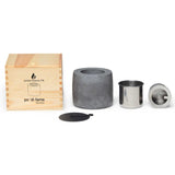 Elegant Ambi Flame Pit in sleek black, crafted from cement for indoor/outdoor ambiance, complete with stainless steel canisters.