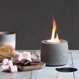 Ambi Flame Pit: sleek cement design with stainless steel canisters, perfect for indoor and outdoor ambience.