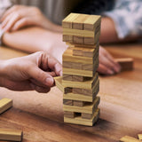 Mini Tumbling Tower set featuring 48 wooden blocks, perfect for family game nights and skill development, stored in a stylish bag.