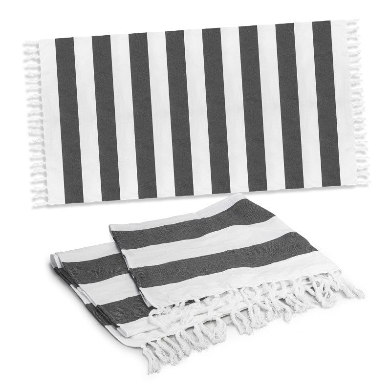 Charcoal cotton towel with a rustic weave, elegant stripes, and fringed trim, perfect for beach outings and picnics.