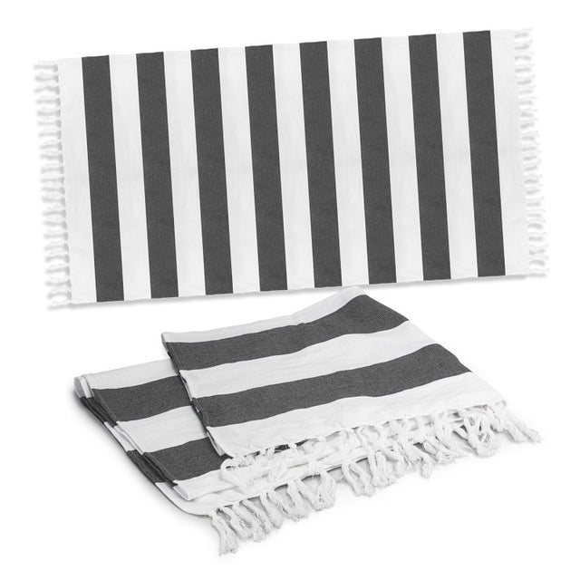 Charcoal cotton towel with a rustic weave, elegant stripes, and fringed trim, perfect for beach outings and picnics.