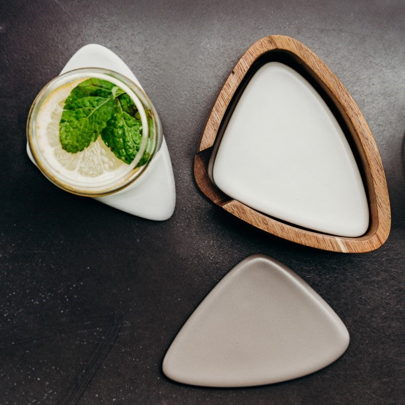 Set of six natural-looking ceramic coasters in grey and taupe with an Acacia wood holder, perfect for stylish surface protection.