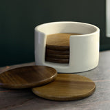 Set of six natural Acacia wood coasters in a black keepsake box, featuring unique grain patterns and a ceramic holder for storage.
