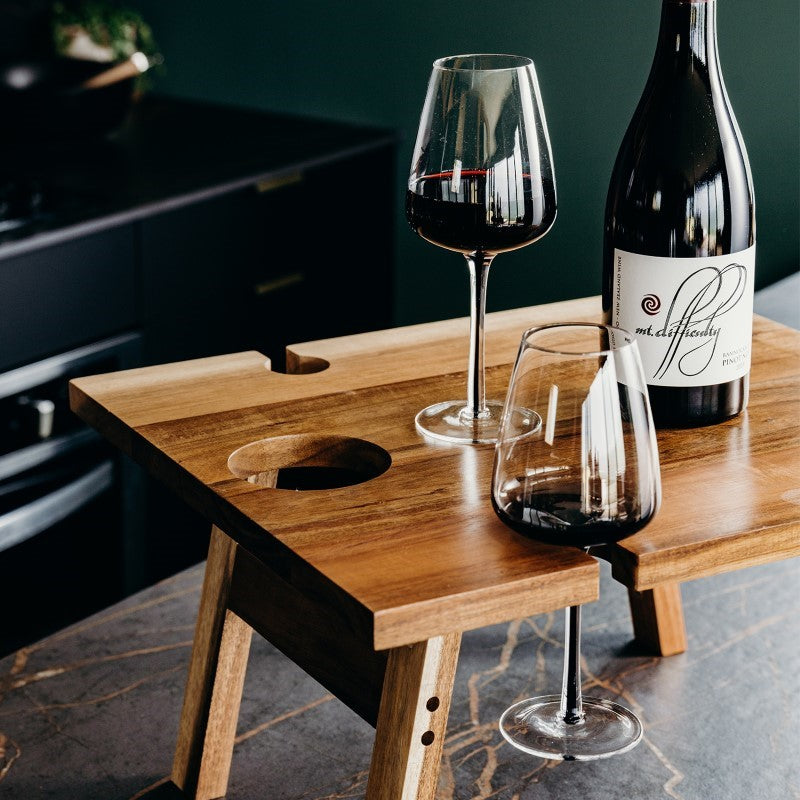 Folding Acacia wood wine table with holders, magnets for stability, compact design, ideal for outdoor gatherings, beautifully packaged.