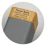 Eco-friendly charcoal power bank with limestone and bamboo, 1200mAh capacity, fast charging, and LED indicator.