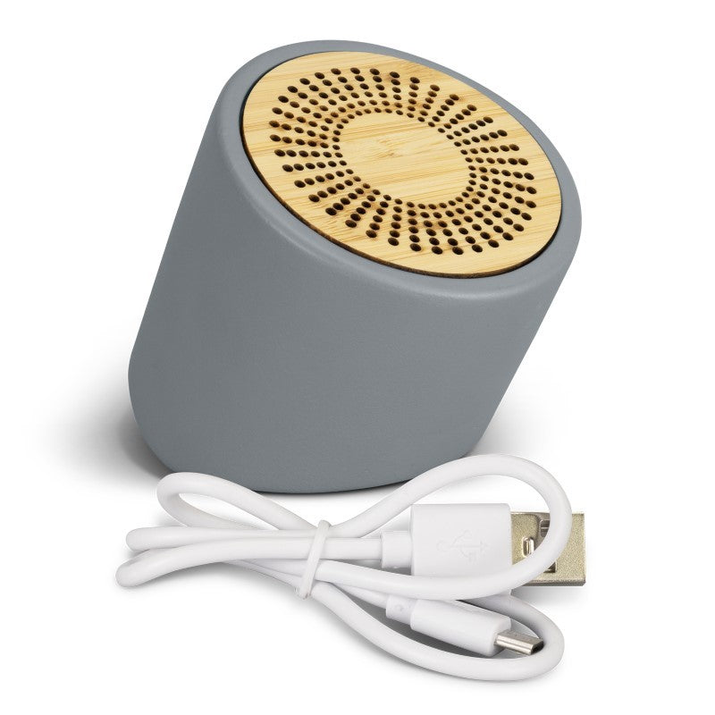 Stylish Bluetooth mini speaker with limestone casing, bamboo grill, 3W sound, and 3-hour playtime.