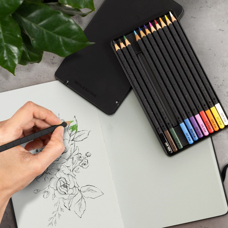 Moleskine art sketching kit with a black hard cover notebook, watercolour pencils, and stylish design for creative expression.