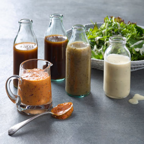 A 2L bottle of Smart Choice French dressing with honey, olive oil, herbs, and spices for salads and marinades.