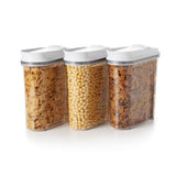 A set of three OXO Good Grips cereal dispensers with airtight seals, perfect for keeping cereals and snacks fresh and organized.