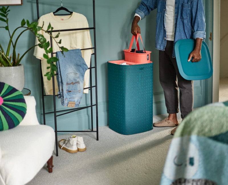 Stylish green laundry separation basket with three removable 30L tote bags for organized washing of light, dark, and colored fabrics.