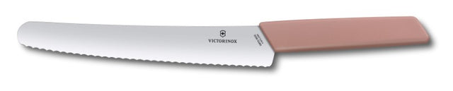 Victorinox Swiss Modern 22 cm bread and pastry knife with ergonomic pink handle and wavy stainless steel blade.