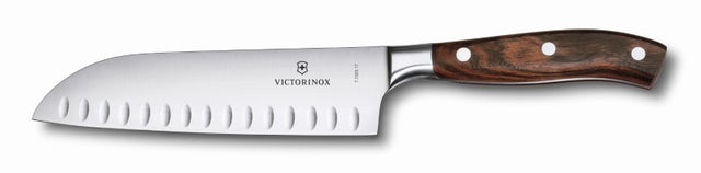 Victorinox Grand Maître 17cm Santoku knife with fluted edge, wooden handle, perfect for precise slicing and dicing in the kitchen.